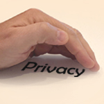 Hand protecting the word privacy